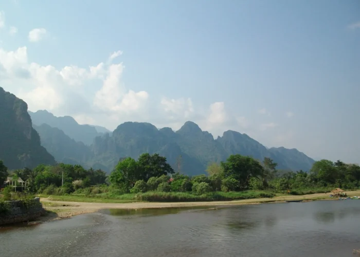 Rio, vegetação e montanhas na paisagem do Laos.